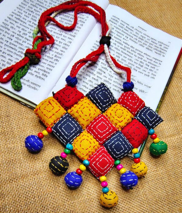 Handmade jewellery set with colorful fabric necklace and matching earrings.