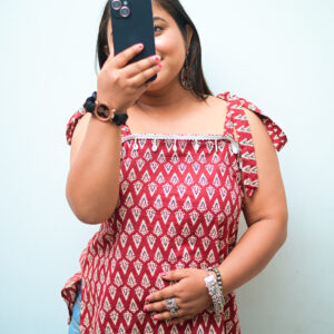 Sleeveless short kurti for women in maroon with white prints, lace detailing, and backless design